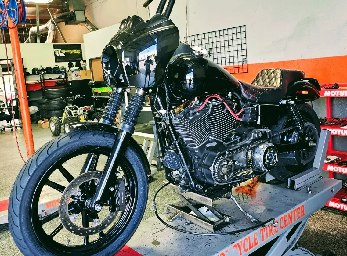 Harley-Davidson Dyna on the lift at Motorcycle Tire Center — factory maintenance service Orange CA